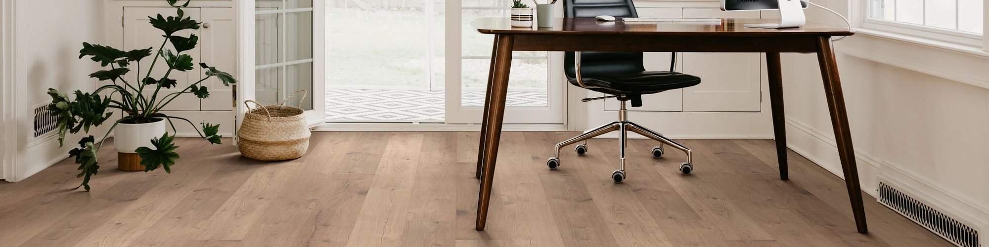 Living room with wood-look laminate flooring from Carpet Design Center in the Greenville, NC area
