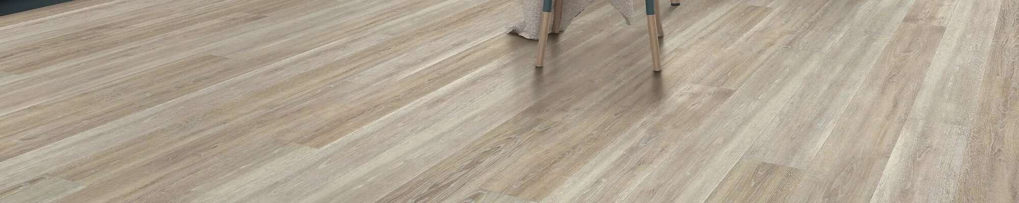 Woman choosing from flooring swatches in store - Carpet Design Center in the Greenville, NC area